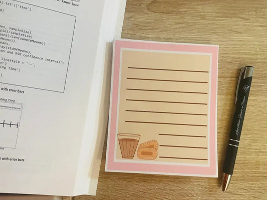 Chai and Biscuit, 4.5 inch by 5.5 inch Memo Pad, tan page with pink and white border, glass of chai and 2 cookies in the bottom left corner, lined 50 sheets, not a sticky note pad, Pyari Paper Shop